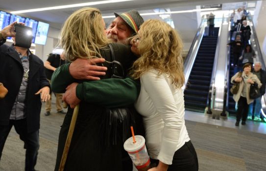 Eddy Lepp is hugged by Aundre Speciale, left, and Karyn Peto, right, at San Francisco International Airport in San Francisco, Calif., on Wednesday, Dec. 7, 2016. Lepp, a major figure in the Bay Area and Northern California marijuana community, was released from federal prison in Colorado after serving 8.5 years for growing marijuana. (Dan Honda/Bay Area News Group)